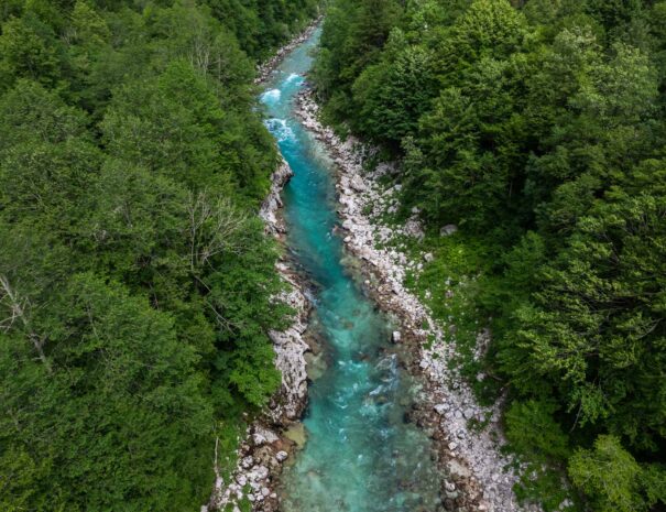 Aerial drone view of Soca river and green lush landscape in Slovenia at summer